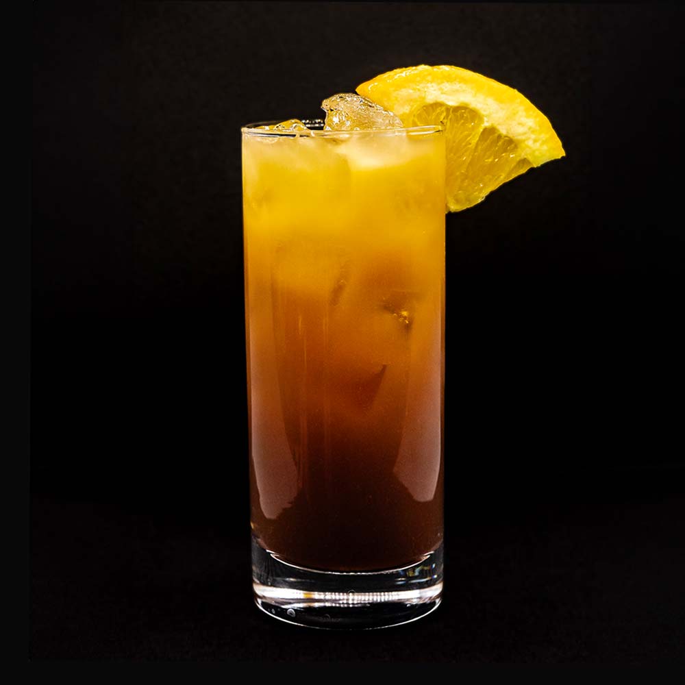 B6D cocktail with orange garnish in tall glass